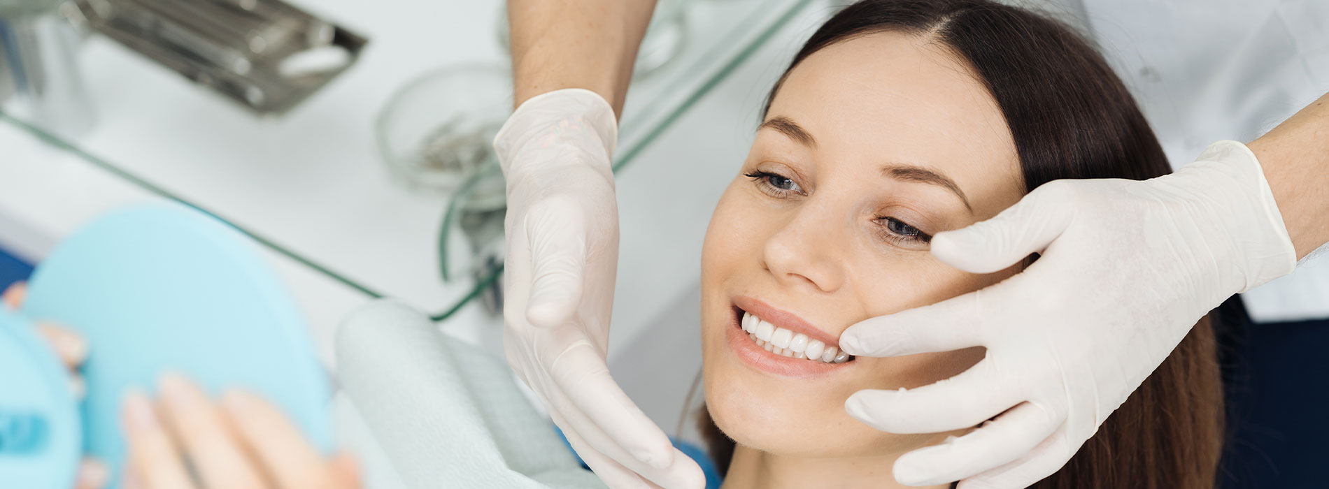 The image shows a woman being attended to by a professional in what appears to be a beauty or skincare setting, with a focus on her face being treated or examined.